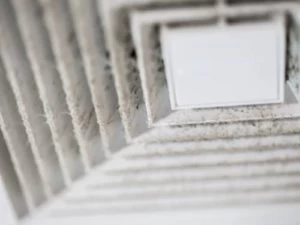 Close-up of a dusty and dirty air vent or HVAC register with visible buildup on the slats, highlighting the need for air duct services New Jersey to ensure proper cleaning and maintenance.