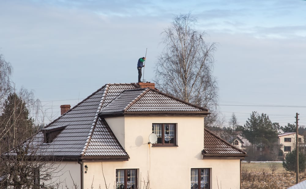 technician working on a roof.