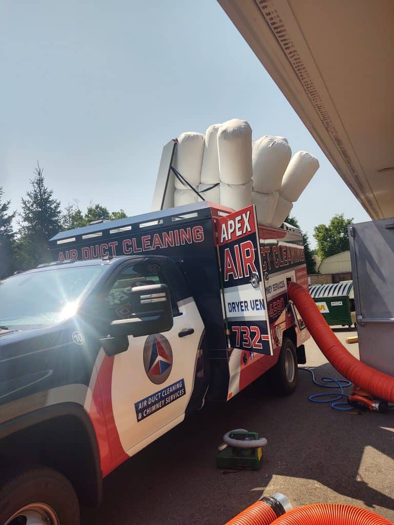 apex chimney repair truck with air duct bags in the truck.