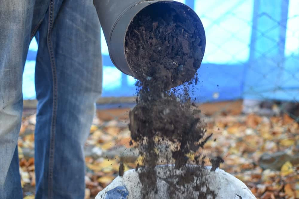 Man Cleaning Chimney Pipe Outside. Cleaning A Wood Burning Stove.