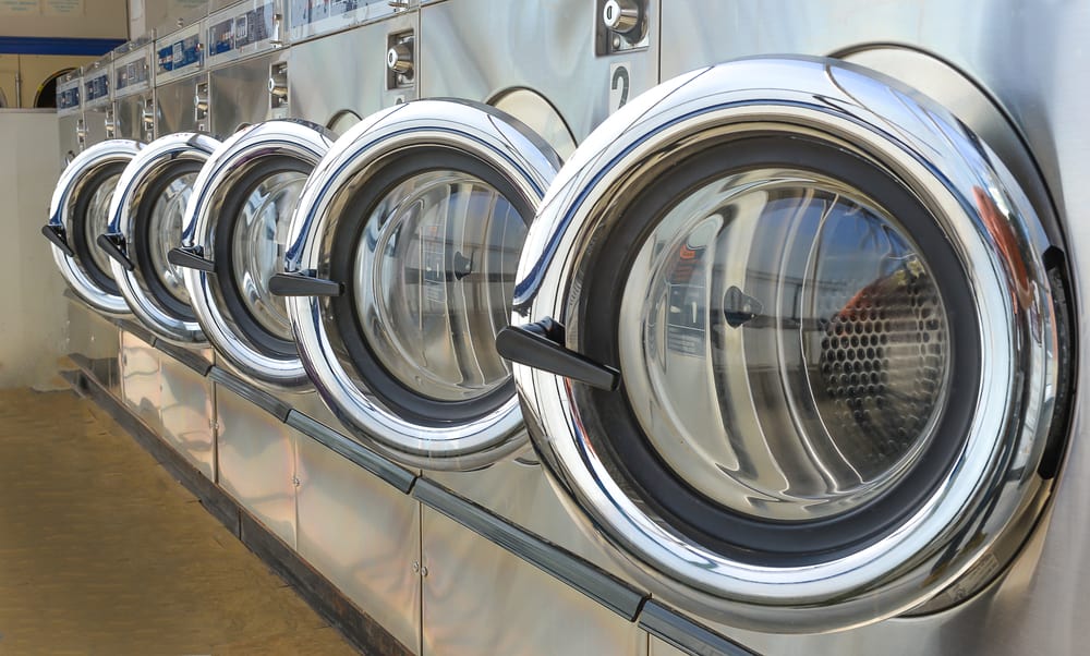 dryers in a row at a laundromat.