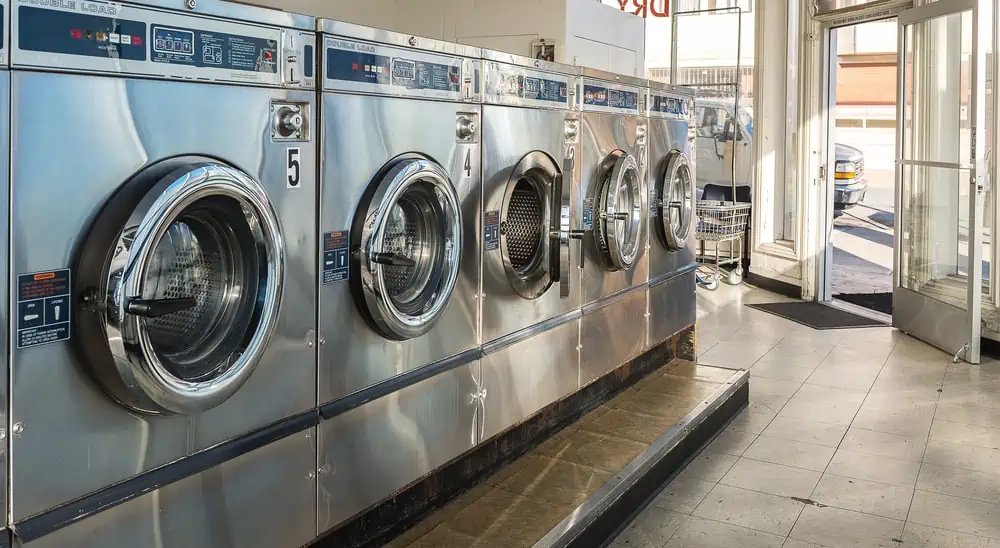 old washers and dryers at a laundromat.