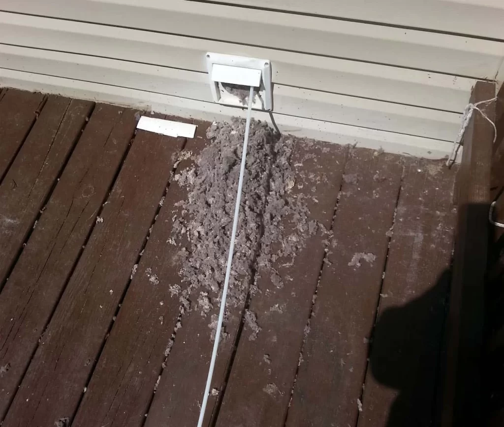 A white wire is connected to a wooden deck.