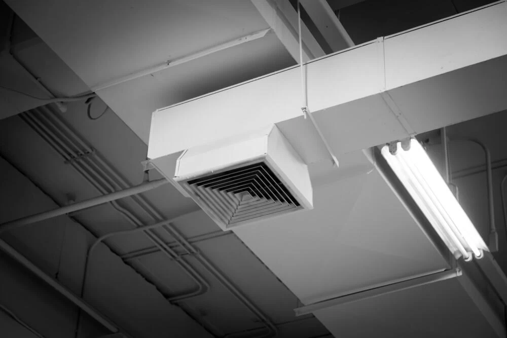 Black and white photo of a ceiling fan.