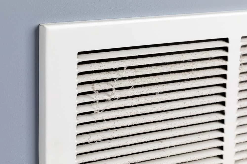 A white air conditioner with a vent cover.