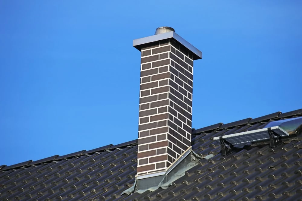 A chimney on the roof of a house.