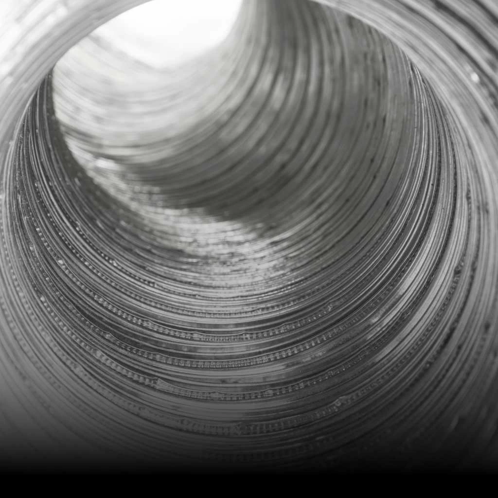 This image shows a dryer vent system with visible lint accumulation, highlighting a common hazard that can reduce dryer efficiency and increase fire danger.