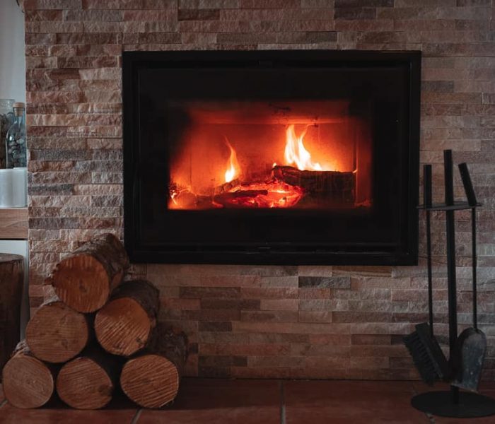 Nice,And,Warm,Fireplace,With,Small,Logs,Near,Of,It