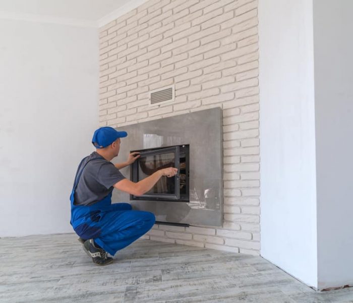 Fireplace,Installing,In,White,Brick,Wall